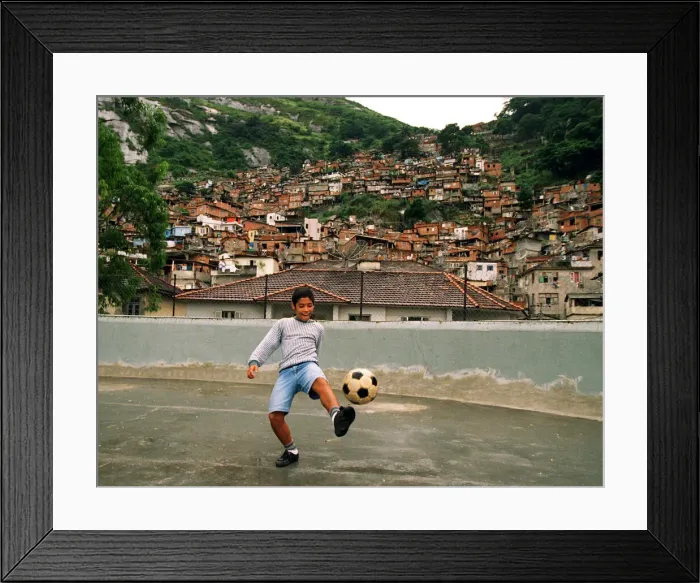 Framed Print : Brazil World Cup feature in Rio De Janeiro. 12 year old Vitor Pedrosa from the Dona