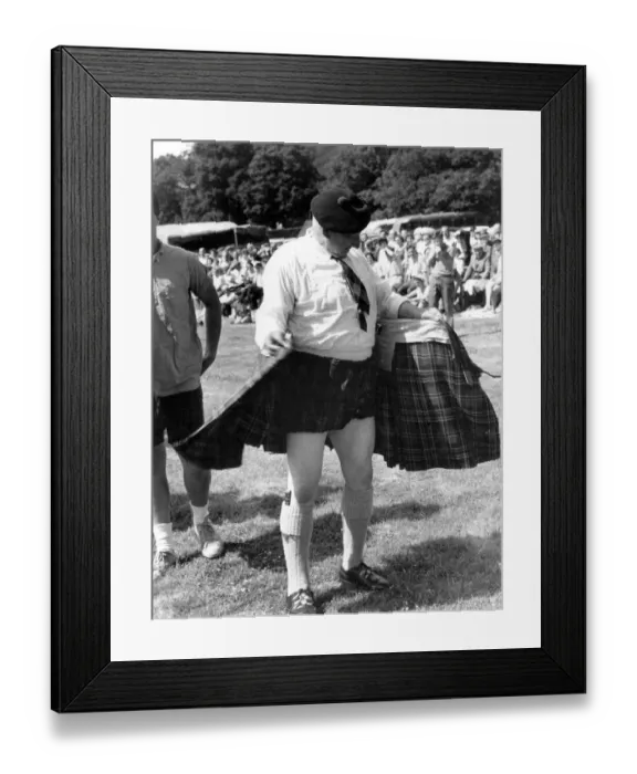 Framed Print : Spectators a Luss Highland Gathering cheered as 71-year-old games president Bob Kerr