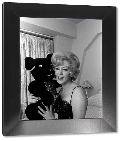 Singer Kathy Kirby singer holding a teddy bear. 14th January 1964