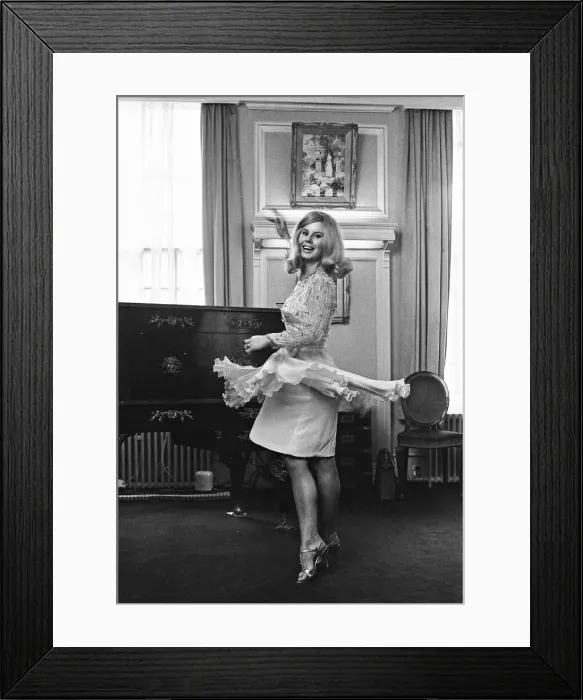 Framed Print : Tina Moore 23, wife of England Captain Bobby Moore, trying on the new dress she will wear Framed Print : Tina Moore 23, wife of England Captain Bobby Moore, trying on the new dress she will wear