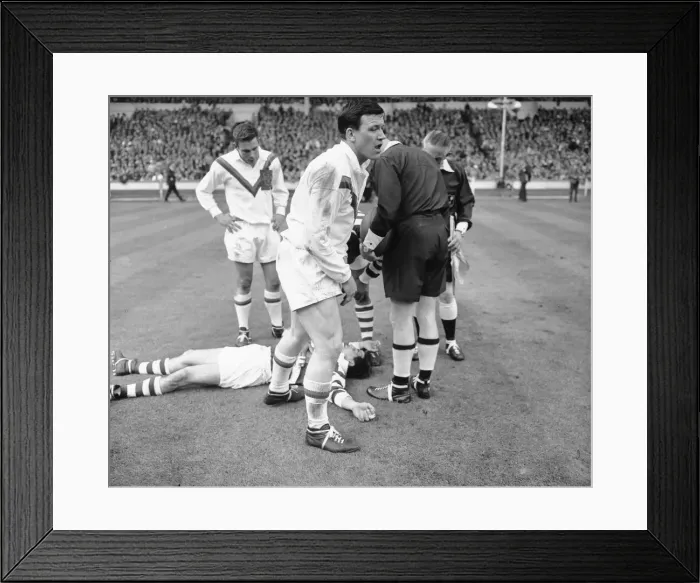 Framed Print : Wigan full back Bolton lies on the ground concussed after the half time whistle had blown Framed Print : Wigan full back Bolton lies on the ground concussed after the half time whistle had blown