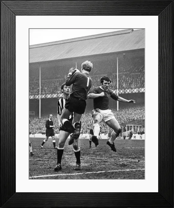 Framed Print : Johnny Morrissey of Everton leaps for the ball as Newscastle keeper Willie McFaul comes