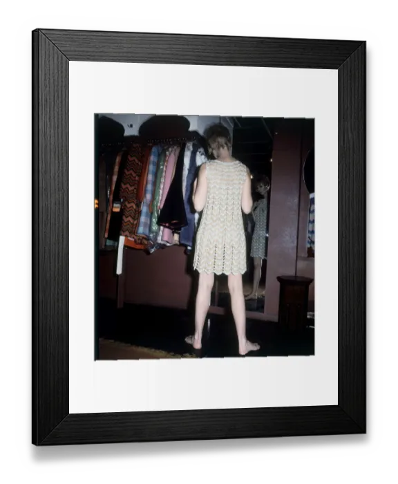 Framed Print : Michelle Desange tries on a chain mail dress while shopping in the Lady Jane Boutique