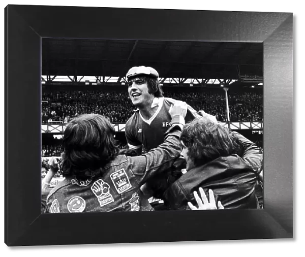 Everton forward Bob Latchford mobbed by jubilant fans after scoring his 30th goal of