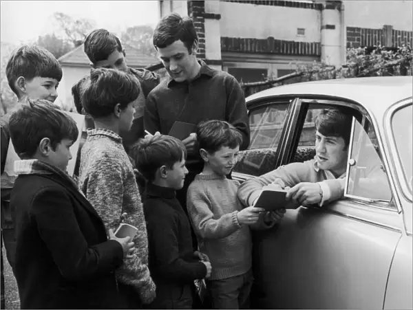 Everton footballers Colin Harvey and Howard Kendall sign autographs for young fans