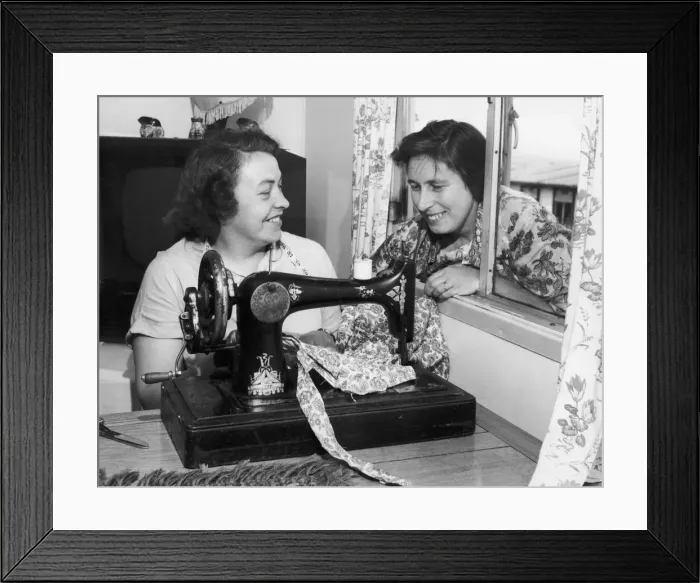 Framed Print : Busy at her sewing machine is Mrs. Beaty Evans, her next door neighbour, Mrs Framed Print : Busy at her sewing machine is Mrs. Beaty Evans, her next door neighbour, Mrs