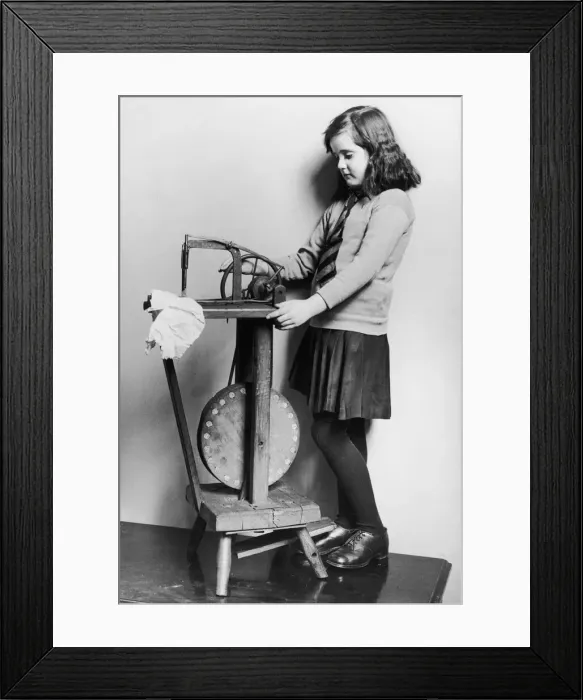 Framed Print : Corinne Griffith seen here in the role of Mary Boyne sitting working at a Singer sewing