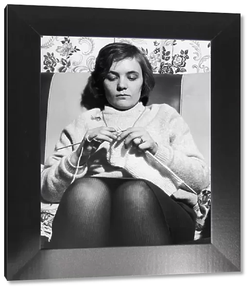 Woman seen here knitting a jumper circa 1965