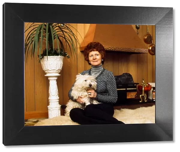 Betty Lawrie at home holding dog March 1975