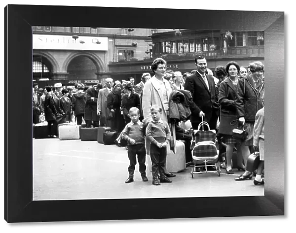 Holidaymakers and families queue for trains at Glasgow Central Station, Glasgow, Scotland