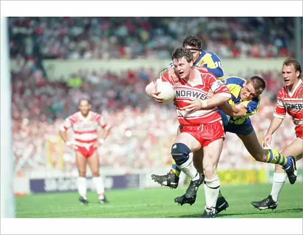 A desperate Warrington defence tries to prevent the Wigan attack from scoring a try in