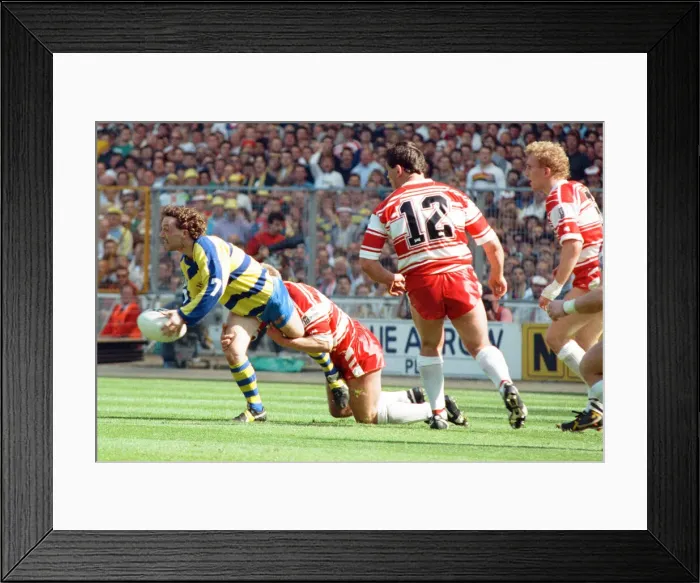 Framed Print : Warringtons Paul Bishop gets the ball away just as the Wigan defence close him down