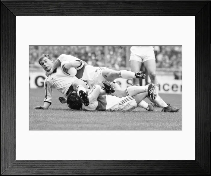 Framed Print : A Widnes player is brought down by a high tackle during the Rugby League Cup Final Framed Print : A Widnes player is brought down by a high tackle during the Rugby League Cup Final