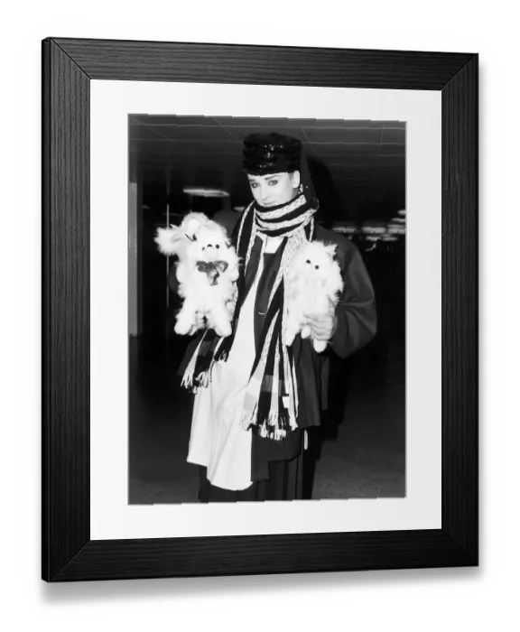 Framed Print : Singer Boy George arrives at Heathrow airport carrying two furry toy animals wearing Framed Print : Singer Boy George arrives at Heathrow airport carrying two furry toy animals wearing