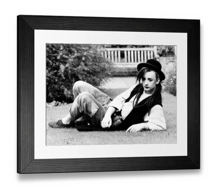 Framed Print : Singer Boy George lying on the grass in his garden. 28th September 1982
