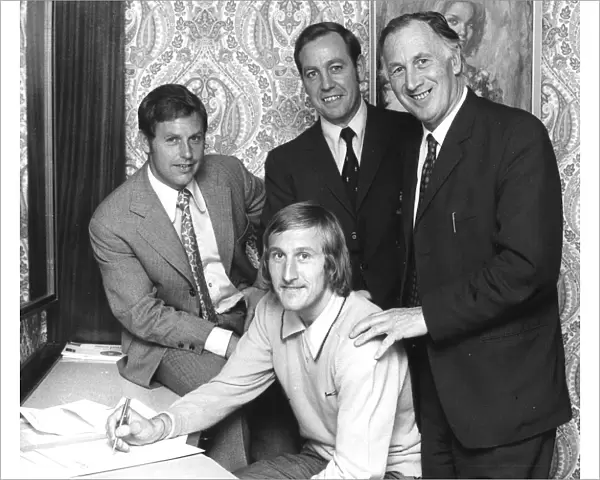 Tommy Hutchison signs for Coventry City in his bedroom at the Hotel Leofric on his