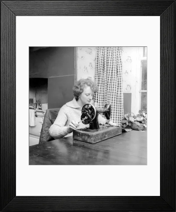 Framed Print : Woman using sewing machine. Circa 1964 A1137b-002 Framed Print : Woman using sewing machine. Circa 1964 A1137b-002