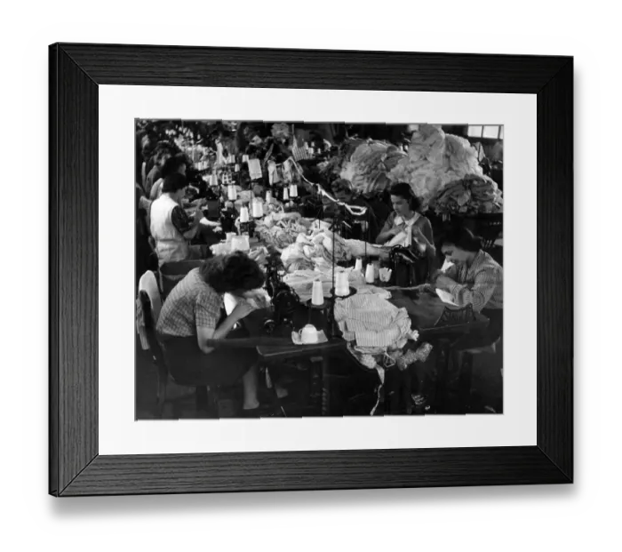 Framed Print : Clothing Industry: Girls at work sewing sleeves on to shirt in the sewing department Framed Print : Clothing Industry: Girls at work sewing sleeves on to shirt in the sewing department