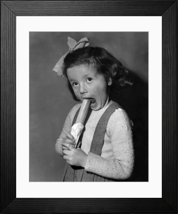 Framed Print : Hazel Robson seen here enjoying her stick of Blackpool Rock. 29th January 1952 Framed Print : Hazel Robson seen here enjoying her stick of Blackpool Rock. 29th January 1952