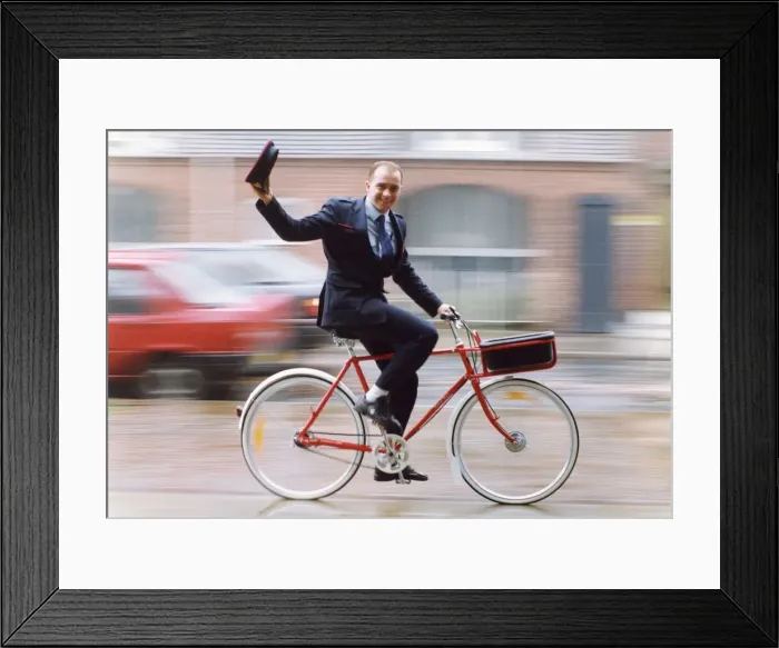 Framed Print : Stratford postie Steve Nokes delivers the mail on a new bicycle. Craftsmen at W. R Framed Print : Stratford postie Steve Nokes delivers the mail on a new bicycle. Craftsmen at W. R