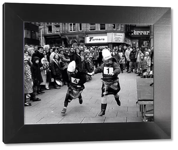 Two youngsters battle it out in the Shrove Tuesday Pancake race at Grey