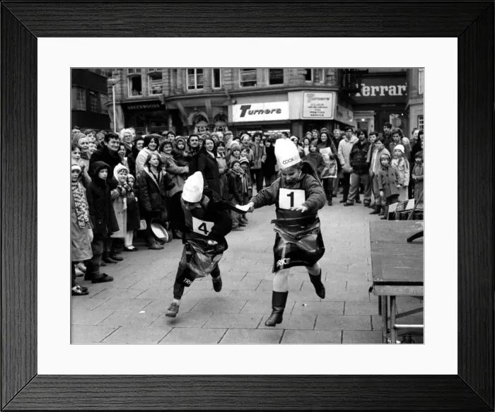 Framed Print : Two youngsters battle it out in the Shrove Tuesday Pancake race at Grey Framed Print : Two youngsters battle it out in the Shrove Tuesday Pancake race at Grey