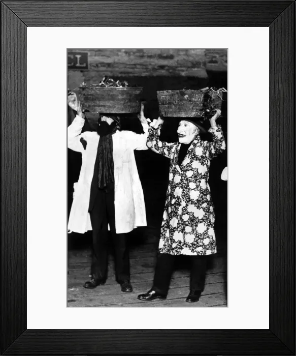 Framed Print : Two of the old time guisers who take part in the tar barrel fire festival by which