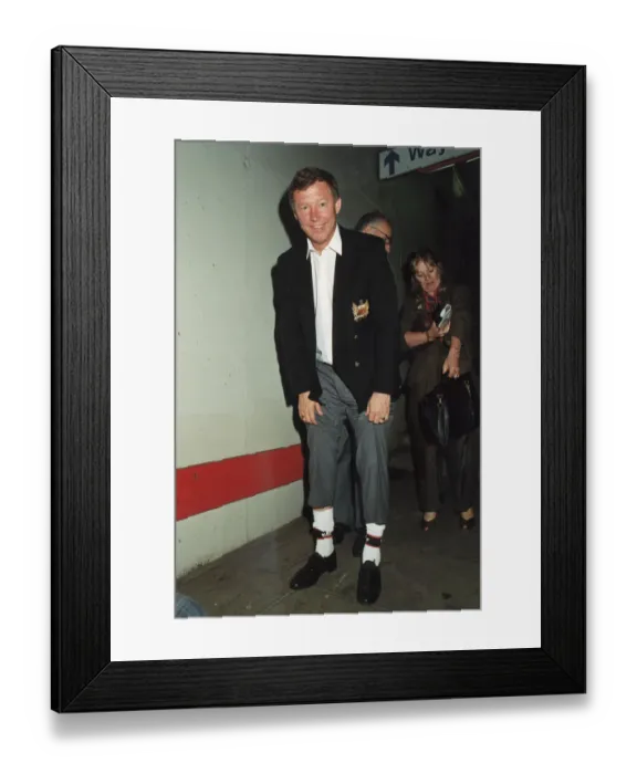 Framed Print : Manchester United manager Alex Ferguson shows off his lucky socks after his teams victory Framed Print : Manchester United manager Alex Ferguson shows off his lucky socks after his teams victory