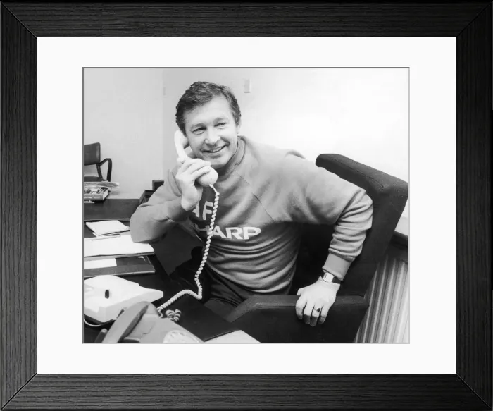 Framed Print : Manchester United manager Alex Ferguson speaking on the telephone in his office Framed Print : Manchester United manager Alex Ferguson speaking on the telephone in his office