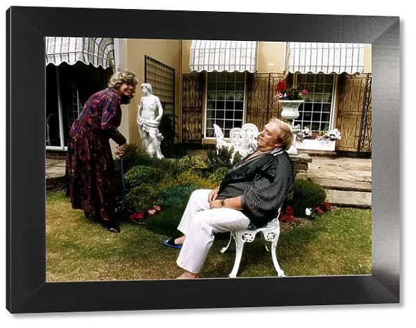 Les Dawson Comedian with wife in garden pretending he is exhausted