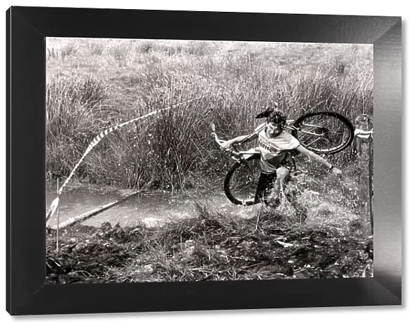 Mind how you go... a competitor carries his cycle across one of the many bogs negotiated