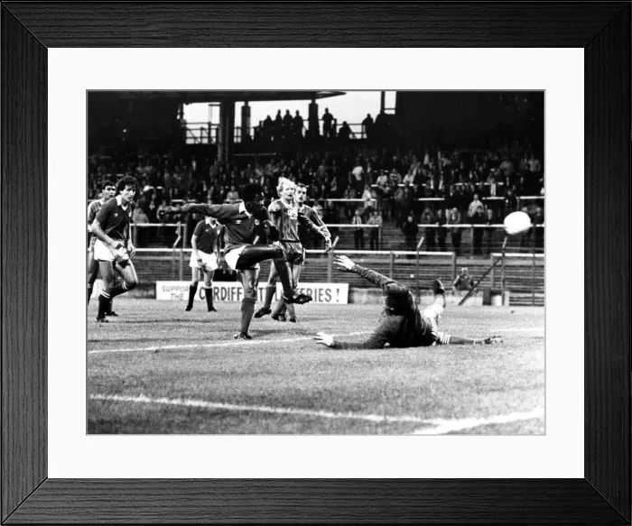 Framed Print : ) watches as Dave Bennett scores against Hereford goalkeeper John Jackson. Aug 1982