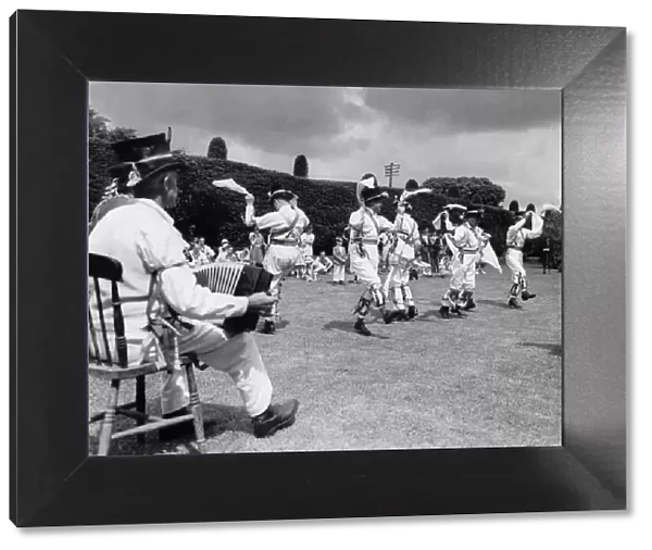 Morris dancers at Thaxted in Essex perform on the village green. June 1939 P029097