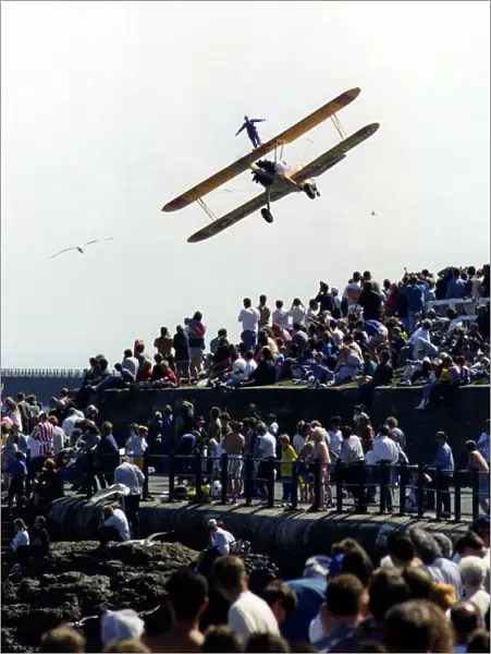 A wing walker performs on the Cadburys Crunchie Boeing-Stearman Model 75 biplane at