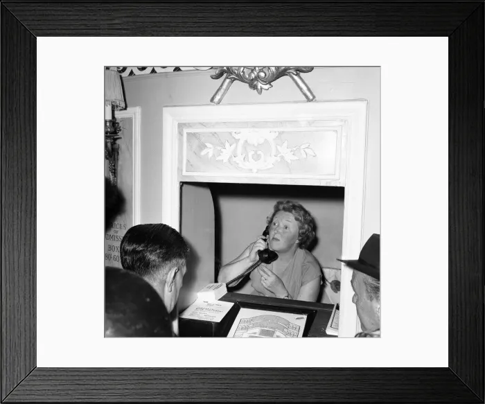 Framed Print : A worker on the telephone at the box office of The Duke of Yorks theatre in the West End