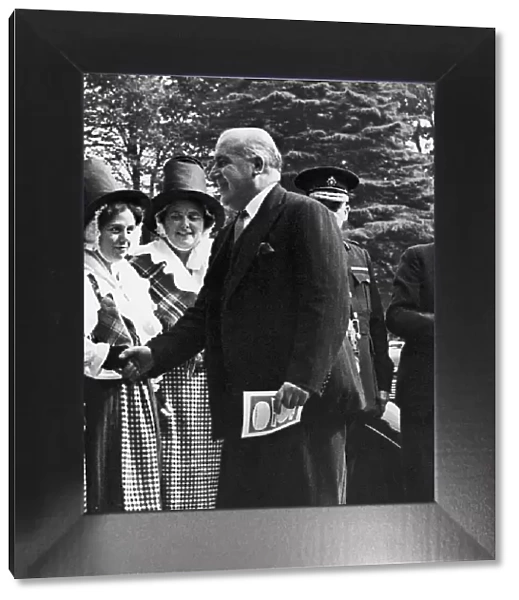 Home Secretary David Maxwell Fyffe greets a woman in national dress at the Welsh