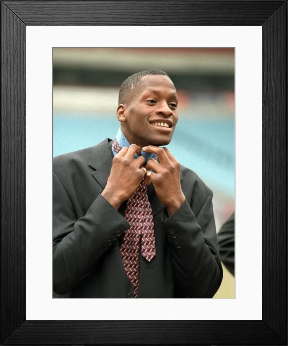 Framed Print : Aston Villa football player Ugo Ehiogu tying up his tie as he gets ready for the team