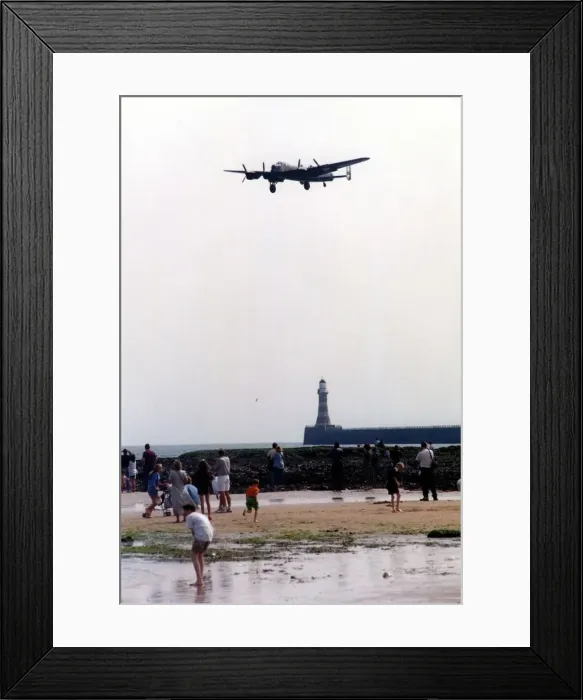 Framed Print : An Avro Lancaster bomber aircraft of the Battle of Britain Memorial Flight flies past
