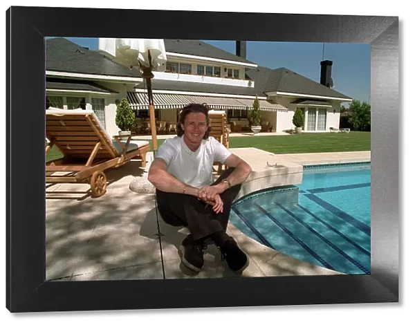 New Real Madrid signing Steve McManaman sitting beside the pool at his new home in Madrid
