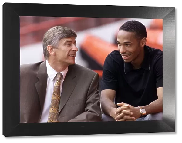Arsenal footballer Thierry Henry with manager Arsene Wenger at Highbury after signing for