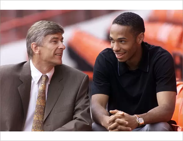 Arsenal footballer Thierry Henry with manager Arsene Wenger at Highbury after signing for