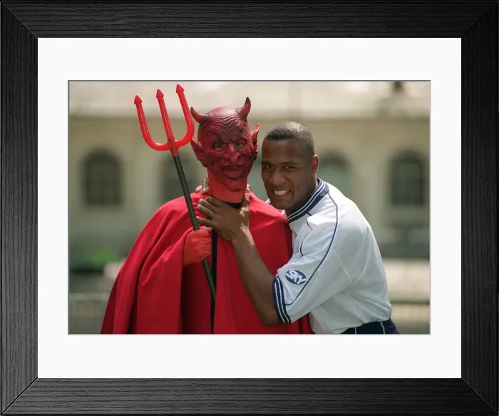 Framed Print : Tottenham Hotspur striker Les Ferdinand poses with a Manchester United Red Devil Framed Print : Tottenham Hotspur striker Les Ferdinand poses with a Manchester United Red Devil