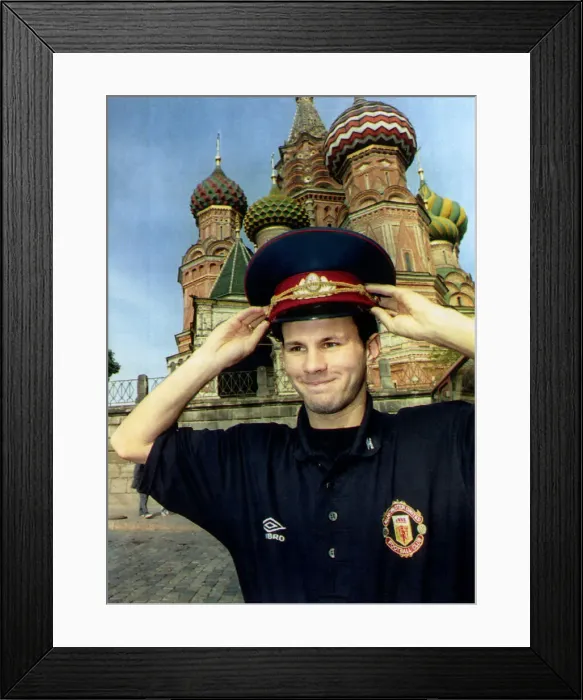 Framed Print : Manchester United star Ryan Giggs poses wearing Russian military hat in front of St Framed Print : Manchester United star Ryan Giggs poses wearing Russian military hat in front of St