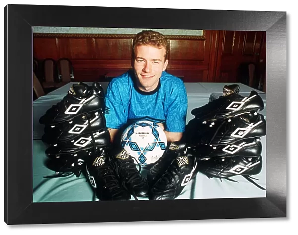 England footballer Alan Shearer footballer posing surrounded by football boots, 1992