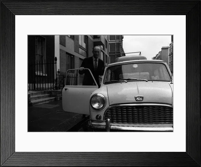 Framed Print : Lord Montagu April 1963 getting into his mini after lunch with Duke of Bedford in