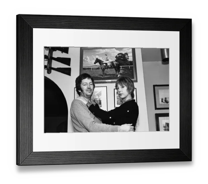 Framed Print : Eric Clapton and wife Pattie, pictured in front of a photograph of his racehorse Via