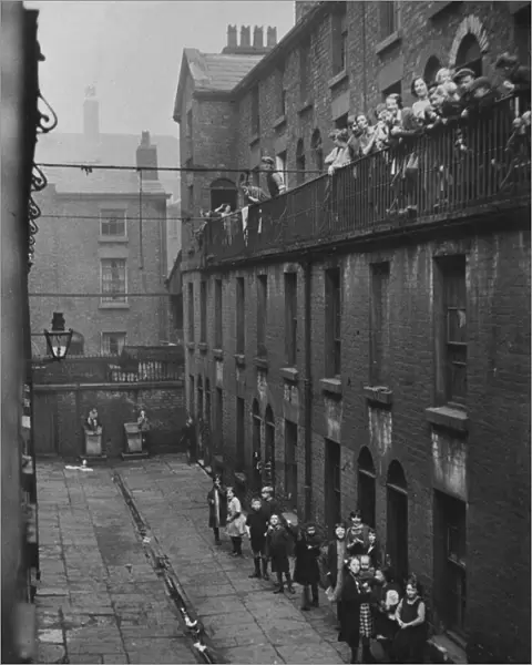 Residents of a Liverpool terrace pose for the Daily Herald photographer. 2nd March, 1933