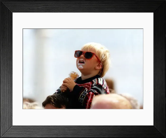 Framed Print : Two year old Craig Emmerson enjoys an ice cream whist watching an air display