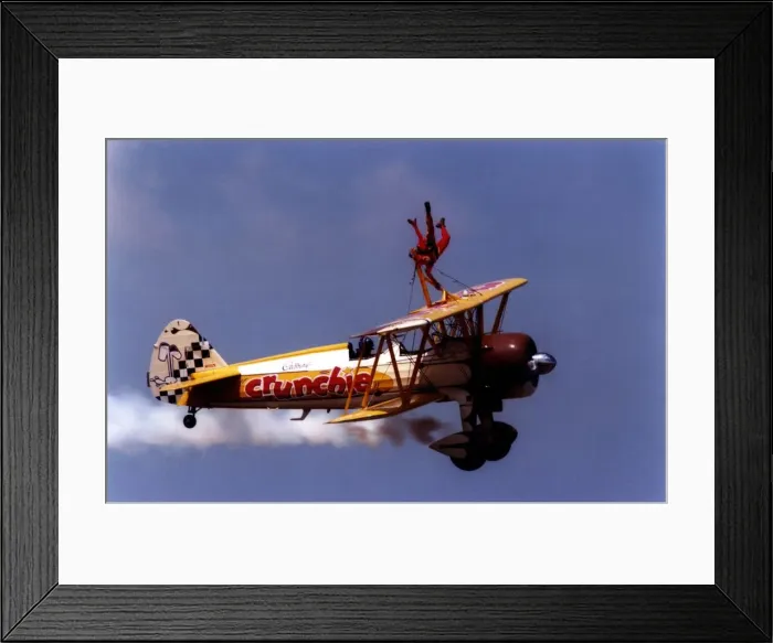 Framed Print : A wing walker performs on the Cadburys Crunchie Boeing-Stearman Model 75 biplane