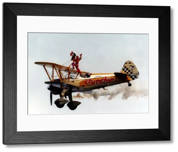 Framed Print : A wing walker performs on the Cadburys Crunchie Boeing-Stearman Model 75 biplane Framed Print : A wing walker performs on the Cadburys Crunchie Boeing-Stearman Model 75 biplane
